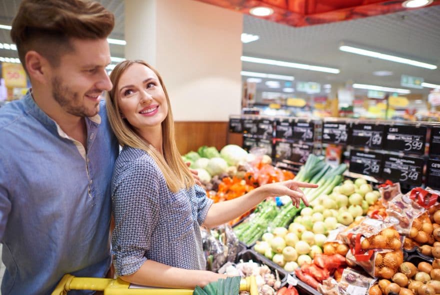 Пара обирає овочі в магазині